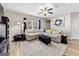Comfortable living room featuring a sectional sofa, ceiling fan, and ample natural light at 4065 Holland Grove, Lawrenceville, GA 30044