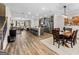Open-concept living space seamlessly connects the kitchen, dining, and living areas with hardwood floors throughout at 4065 Holland Grove, Lawrenceville, GA 30044
