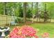 Lush backyard featuring a swing, wooden fence, vibrant greenery, and well-maintained lawn with flower beds at 909 Ne Otter Way Ne Way, Marietta, GA 30068