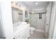 Updated bathroom with a marble vanity, decorative light fixtures, and a glass-enclosed walk-in shower at 909 Ne Otter Way Ne Way, Marietta, GA 30068