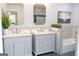 Elegant bathroom featuring dual vanity sinks, marble countertops, and a tiled tub and shower combo at 909 Ne Otter Way Ne Way, Marietta, GA 30068