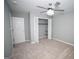 A cozy bedroom features neutral tones, carpet, a ceiling fan, and a closet for storage at 909 Ne Otter Way Ne Way, Marietta, GA 30068