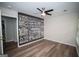 Modern bedroom featuring wood-look flooring and a large wall art piece with motivational typography at 909 Ne Otter Way Ne Way, Marietta, GA 30068