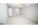 This spacious bedroom includes neutral walls, plush carpeting, and a ceiling fan at 909 Ne Otter Way Ne Way, Marietta, GA 30068