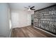 Modern bedroom featuring wood-look flooring and a large wall art piece with motivational typography at 909 Ne Otter Way Ne Way, Marietta, GA 30068