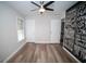Modern bedroom featuring wood-look flooring and a large wall art piece with motivational typography at 909 Ne Otter Way Ne Way, Marietta, GA 30068