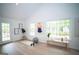 Bright bonus room with tall ceilings, light flooring, large windows, and an exterior door to the backyard at 909 Ne Otter Way Ne Way, Marietta, GA 30068