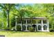 Beautiful two-story home with a classic design, set amidst mature trees and a well-maintained yard at 909 Ne Otter Way Ne Way, Marietta, GA 30068