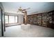 Spacious carpeted living room featuring custom built-in bookshelves and a unique structural support at 909 Ne Otter Way Ne Way, Marietta, GA 30068