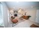 Spacious living room with a brick fireplace, built-in shelving, and modern furniture; perfect for gatherings at 909 Ne Otter Way Ne Way, Marietta, GA 30068