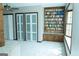 Bright living room features a wall of built-in bookshelves and storage, with natural light from large window at 909 Ne Otter Way Ne Way, Marietta, GA 30068