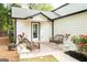 Cozy patio with outdoor seating, decorative plants, rug, and fire pit, adjacent to the white siding of the house at 909 Ne Otter Way Ne Way, Marietta, GA 30068