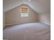 Attic space featuring carpeting, vaulted ceiling, and natural light at 1555 New Ne St, Atlanta, GA 30307