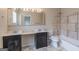 Bathroom featuring double sink vanity, toilet, and tiled shower/tub combo at 1555 New Ne St, Atlanta, GA 30307