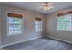 Bedroom featuring three windows with wood blinds and hardwood floors at 1555 New Ne St, Atlanta, GA 30307
