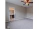 Carpeted bedroom features two bright windows, neutral walls and trim, and a ceiling fan at 1555 New Ne St, Atlanta, GA 30307