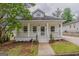 Charming renovated home with a welcoming front porch, landscaped yard, and updated curb appeal at 1555 New Ne St, Atlanta, GA 30307