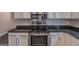 Modern kitchen with stainless steel appliances, granite countertops, and white cabinets at 1555 New Ne St, Atlanta, GA 30307