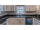 Close-up of renovated kitchen with granite countertops, stainless steel appliances, and neutral-toned cabinets at 1555 New Ne St, Atlanta, GA 30307