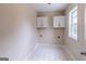 Laundry room features a window and white cabinets at 1555 New Ne St, Atlanta, GA 30307