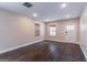 Bright living room featuring wood floors, neutral walls, two windows, and a door leading outside at 1555 New Ne St, Atlanta, GA 30307