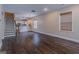 Open-concept living space with hardwood floors flowing into the kitchen and staircase leading upstairs at 1555 New Ne St, Atlanta, GA 30307