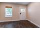 Bright living room featuring wood floors, white trim, a window, and a door leading outside at 1555 New Ne St, Atlanta, GA 30307