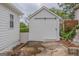 View of detached outbuilding with sliding door and adjacent driveway at 1555 New Ne St, Atlanta, GA 30307