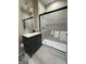 Updated bathroom with a glass-enclosed shower, green vanity, modern fixtures, and stylish tile flooring at 2148 M L King Jr Sw Dr, Atlanta, GA 30310