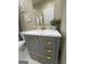 Bathroom features a vanity with drawers and gold hardware and a decorative plant at 2148 M L King Jr Sw Dr, Atlanta, GA 30310