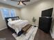 Comfortable bedroom with a queen-sized bed, wood floors, natural light, and a modern dresser at 2148 M L King Jr Sw Dr, Atlanta, GA 30310