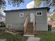 Exterior back view of home with door, wooden staircase and gray siding at 2148 M L King Jr Sw Dr, Atlanta, GA 30310