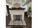 Stylish white brick fireplace with decorative tile and a wood mantel adding character to the living space at 2148 M L King Jr Sw Dr, Atlanta, GA 30310