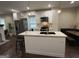 Bright kitchen featuring an island, stainless steel appliances, white cabinetry, and pendant lighting at 2148 M L King Jr Sw Dr, Atlanta, GA 30310