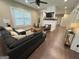 Spacious living room featuring wood floors, a cozy fireplace, and ample natural light from large windows at 2148 M L King Jr Sw Dr, Atlanta, GA 30310