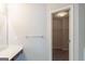 Bright bathroom with a modern vanity, storage and entry to walk-in closet at 513 Shadow Valley Ct, Lithonia, GA 30058