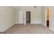 View of a bedroom with neutral walls and carpet, featuring doors to a closet and bathroom at 513 Shadow Valley Ct, Lithonia, GA 30058