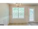 Bright dining area with large window, chandelier, and paneled wainscoting at 513 Shadow Valley Ct, Lithonia, GA 30058