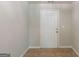 Clean entryway with tile flooring and a white door, providing a welcoming entrance to the home at 513 Shadow Valley Ct, Lithonia, GA 30058