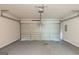 A spacious garage with a clean epoxy floor and neutral walls at 513 Shadow Valley Ct, Lithonia, GA 30058