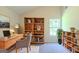 Comfortable office space with a modern desk, shelving units and plenty of natural light for a productive workspace at 513 Shadow Valley Ct, Lithonia, GA 30058