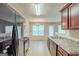 Open kitchen with stainless steel appliances and view to dining area at 513 Shadow Valley Ct, Lithonia, GA 30058
