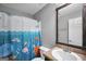 Bathroom featuring a framed mirror, sink, and a shower with a fun ocean-themed curtain at 950 Besse Way, Locust Grove, GA 30248
