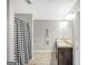 Bathroom with double sinks, wood look floors, gray walls and a shower with a black and white curtain at 950 Besse Way, Locust Grove, GA 30248