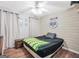 Bedroom featuring a wooden accent wall, wood-look floors, and a ceiling fan at 950 Besse Way, Locust Grove, GA 30248