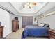 This bedroom features a trey ceiling, ceiling fan, wood-look floors and gray walls at 950 Besse Way, Locust Grove, GA 30248