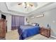 This bedroom features a trey ceiling, ceiling fan, wood-look floors and gray walls at 950 Besse Way, Locust Grove, GA 30248