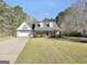Charming home featuring a brick and siding facade, gabled roof, and manicured landscaping at 950 Besse Way, Locust Grove, GA 30248