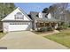 Charming home featuring a brick and siding facade, gabled roof, and manicured landscaping at 950 Besse Way, Locust Grove, GA 30248