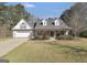 Charming home featuring a brick and siding facade, gabled roof, and manicured landscaping at 950 Besse Way, Locust Grove, GA 30248